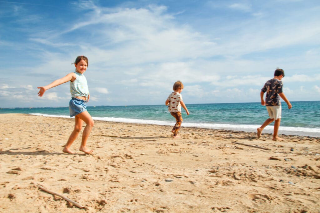 A family on a Blue Flag Algarve beach in soft late afternoon light