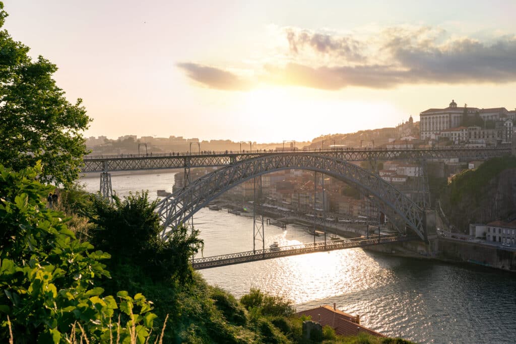Dom luiz brige in Porto on the riverside of Duero river cityscape at sunset from above